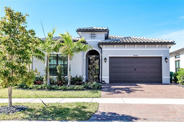 mediterranean / spanish-style house with a garage