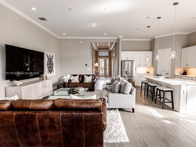 living room with crown molding and sink