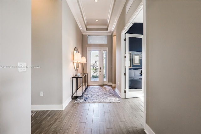 foyer featuring a raised ceiling