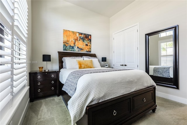 bedroom with light carpet and a closet