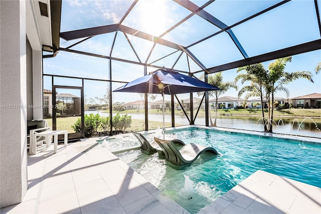 view of swimming pool with pool water feature, glass enclosure, a patio area, and a water view