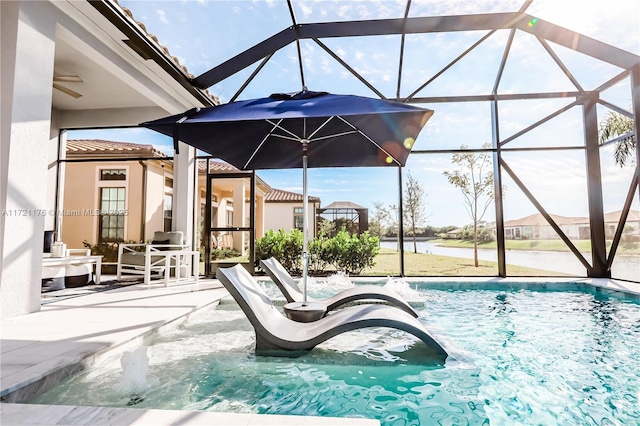 view of swimming pool with glass enclosure and a patio area