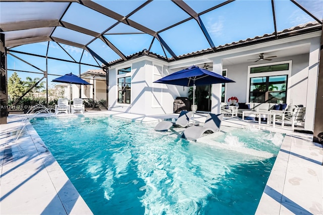 view of pool with pool water feature, ceiling fan, a patio area, and a lanai