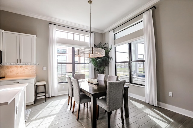 dining room with plenty of natural light and crown molding