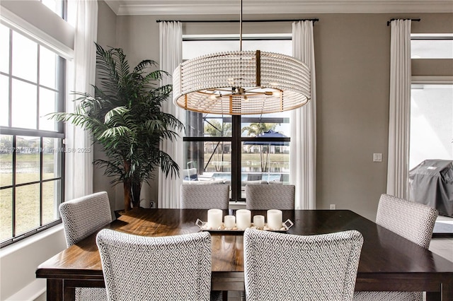 dining space featuring crown molding and a chandelier