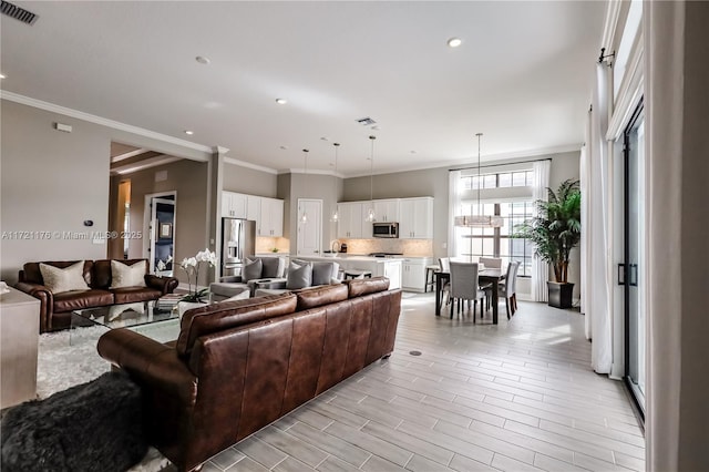 living room featuring crown molding