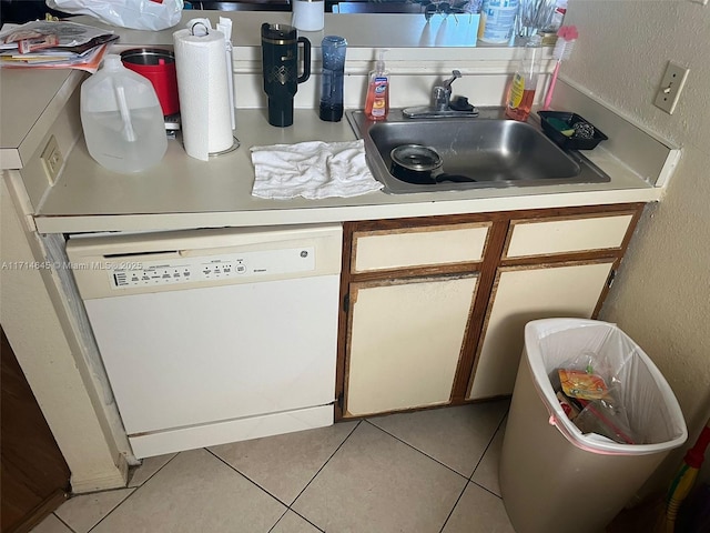 kitchen with dishwasher, light tile patterned floors, and sink