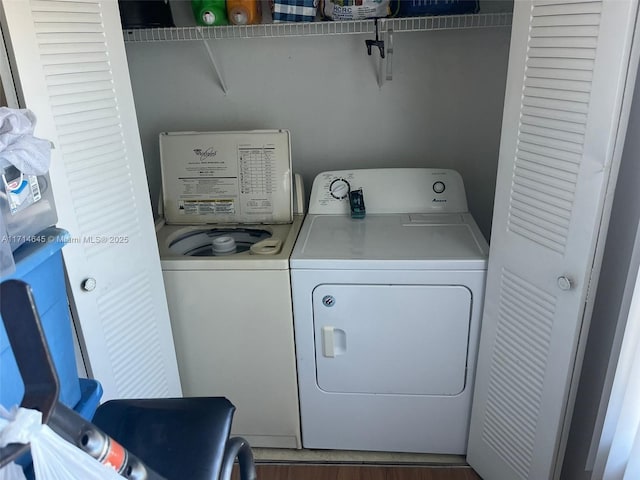 clothes washing area featuring washer and dryer and dark wood-type flooring