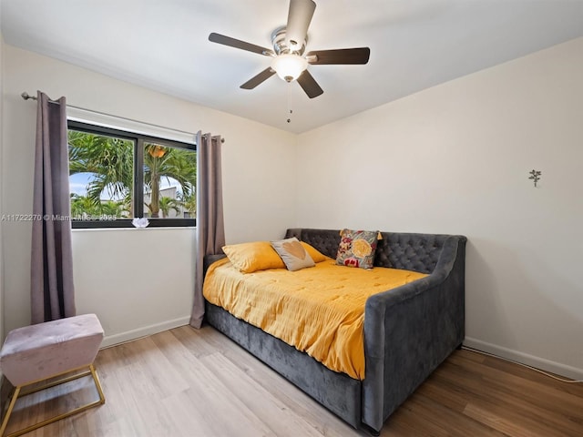 bedroom with ceiling fan and wood-type flooring