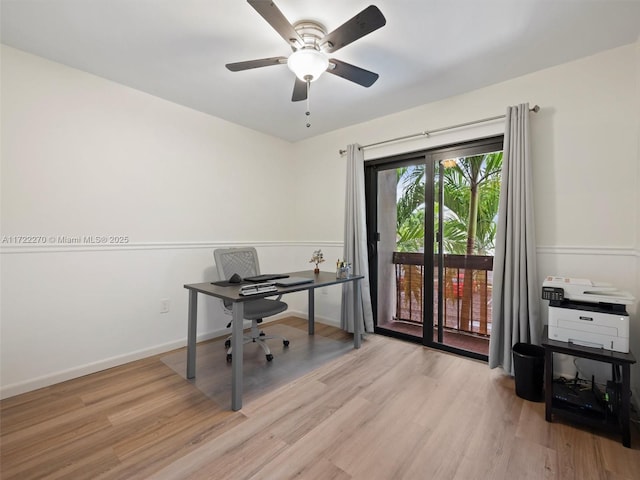 home office with ceiling fan and light hardwood / wood-style flooring