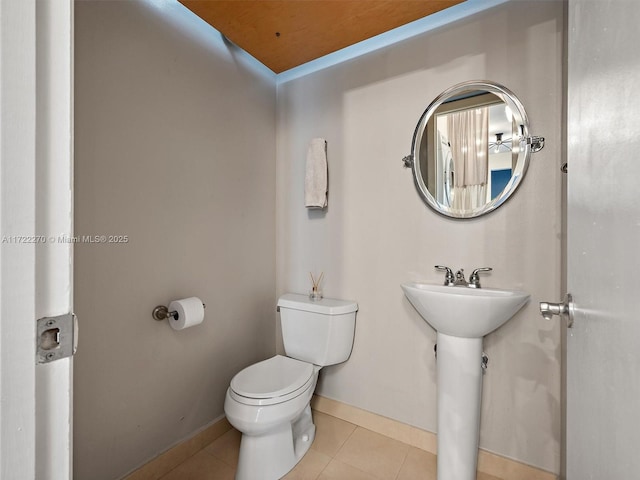 bathroom featuring sink, tile patterned floors, and toilet