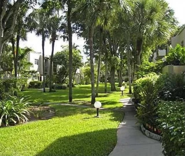 view of home's community featuring a lawn