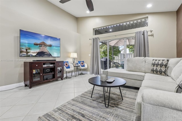 living room featuring ceiling fan, lofted ceiling, and light tile patterned floors