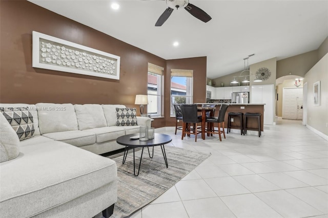 tiled living room featuring ceiling fan and lofted ceiling