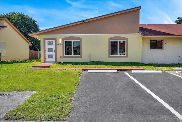 rear view of property with a yard