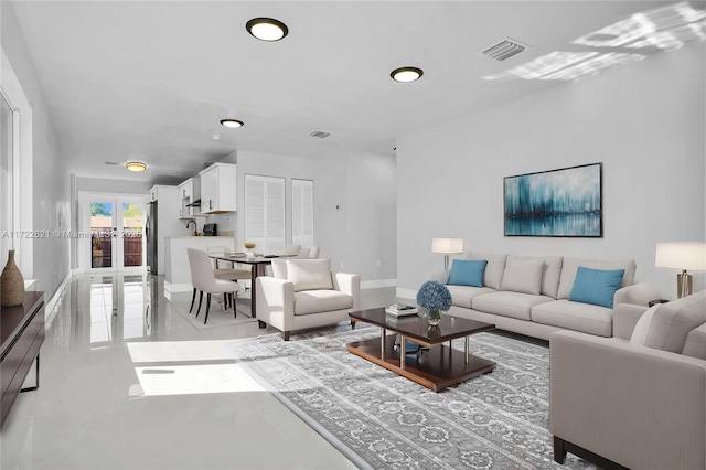 living room with french doors and light tile patterned flooring