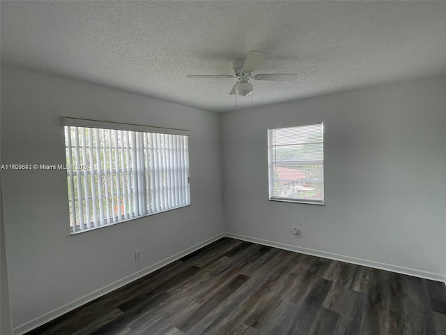 unfurnished room featuring ceiling fan, dark hardwood / wood-style flooring, and a textured ceiling