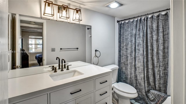 bathroom with toilet and vanity