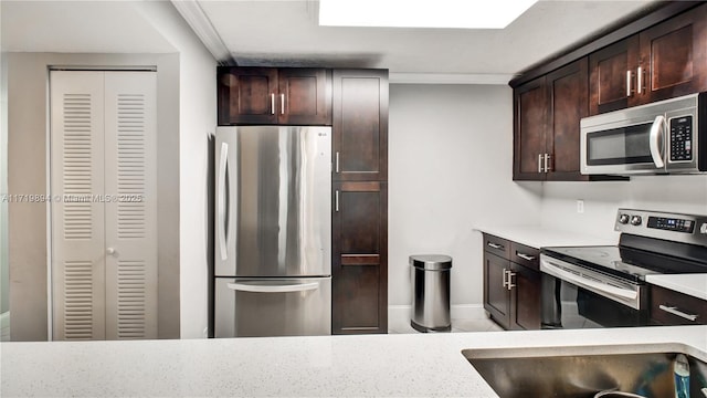 kitchen featuring sink, ornamental molding, dark brown cabinets, and appliances with stainless steel finishes