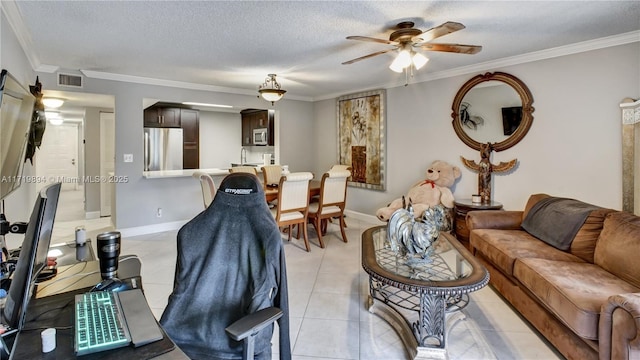 tiled living room featuring a textured ceiling, ceiling fan, and ornamental molding