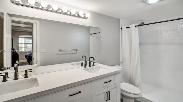 bathroom featuring vanity, toilet, and curtained shower