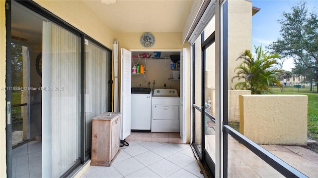 laundry area featuring separate washer and dryer and light tile patterned flooring