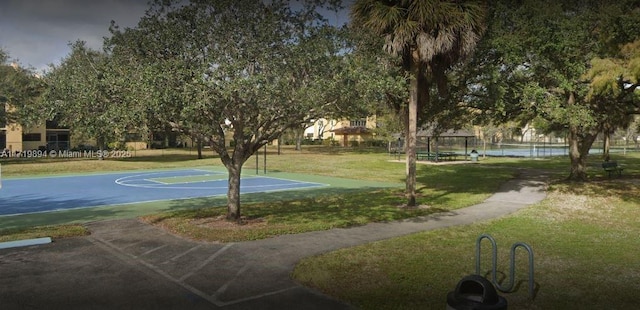 view of basketball court featuring a yard