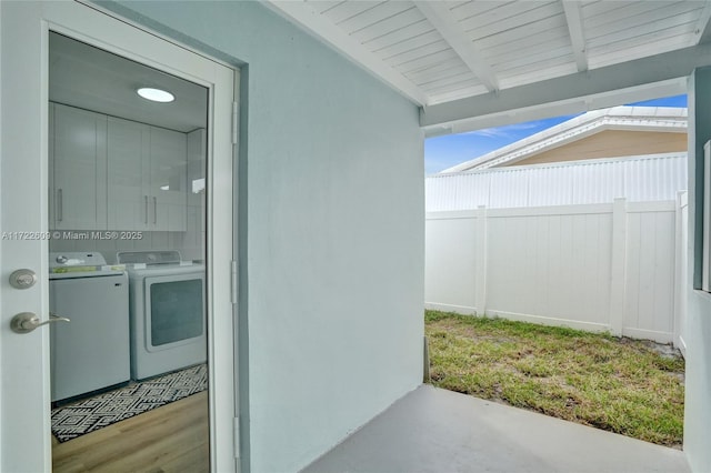 view of exterior entry featuring washing machine and clothes dryer