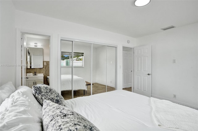 bedroom with ensuite bathroom and sink