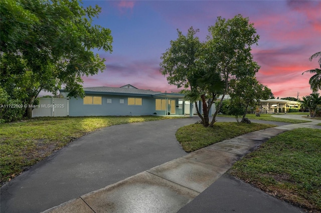 ranch-style home with a yard