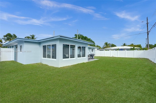 rear view of house with a yard