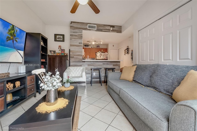 tiled living room with ceiling fan