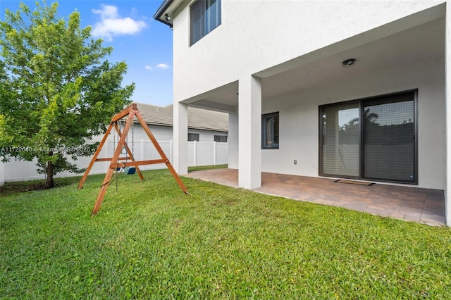 view of yard featuring a playground and a patio