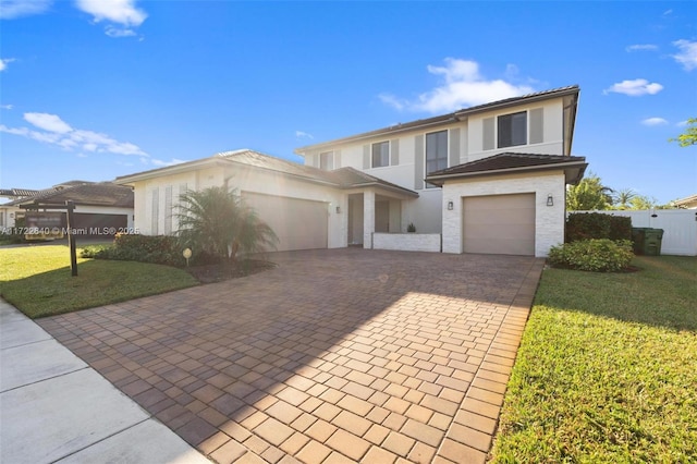 view of front facade featuring a garage and a front lawn