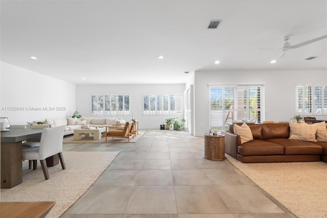 living room featuring a wealth of natural light and ceiling fan