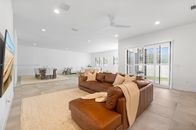 living room featuring ceiling fan and light tile patterned floors