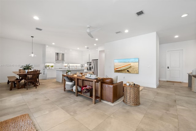 living room featuring ceiling fan and sink