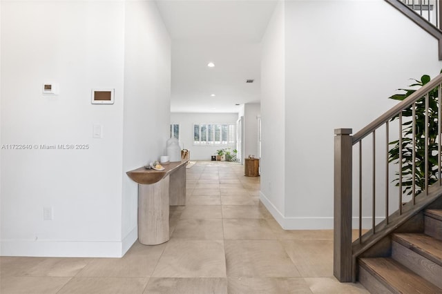 hall with light tile patterned floors