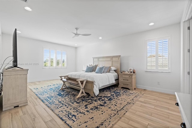 bedroom with ceiling fan and light hardwood / wood-style floors