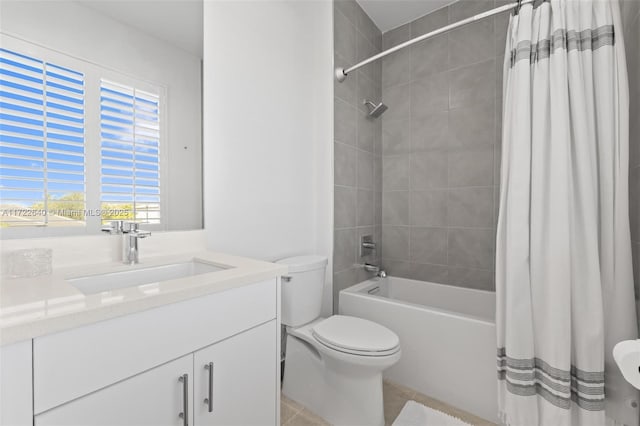 full bathroom featuring tile patterned floors, vanity, toilet, and shower / bath combo with shower curtain