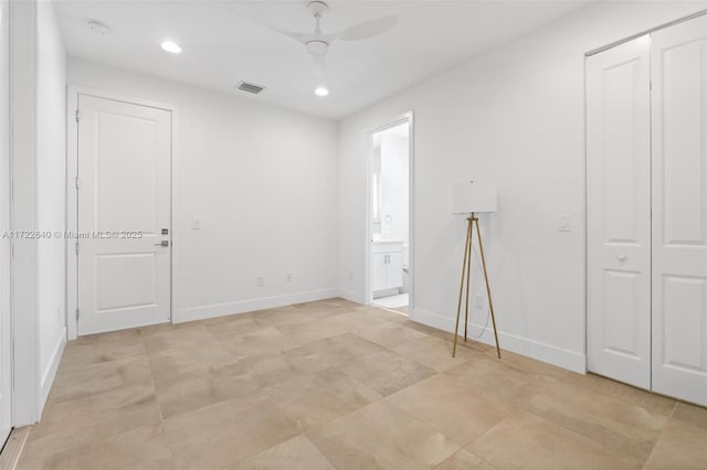 unfurnished bedroom featuring ceiling fan and ensuite bath