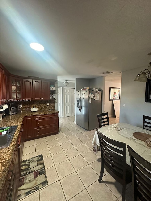 kitchen with sink, backsplash, stainless steel fridge with ice dispenser, and light tile patterned flooring