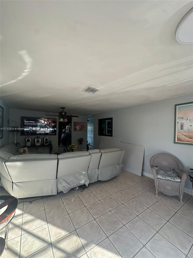 living room with ceiling fan and light tile patterned floors