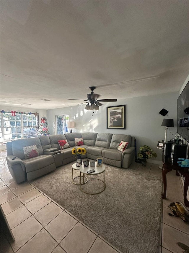 living room with ceiling fan and light tile patterned floors