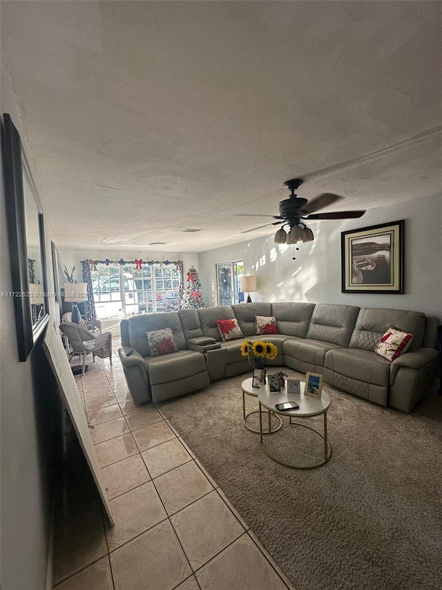 tiled living room with ceiling fan