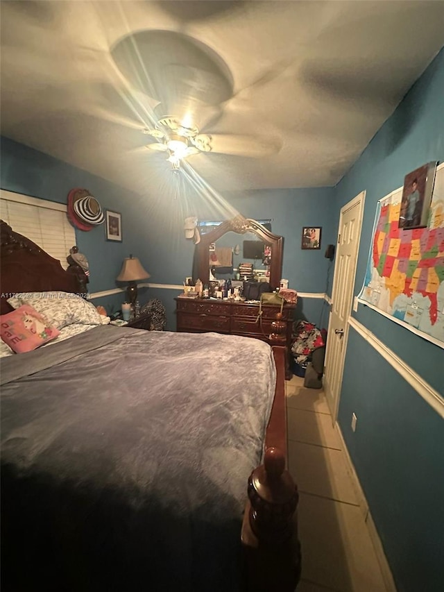 bedroom with ceiling fan and tile patterned flooring