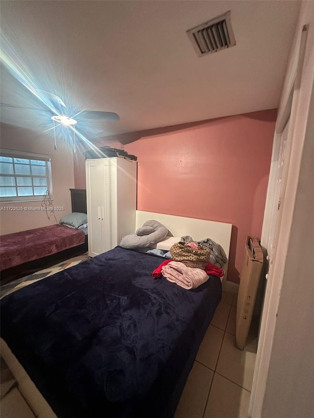 bedroom featuring light tile patterned flooring and radiator heating unit