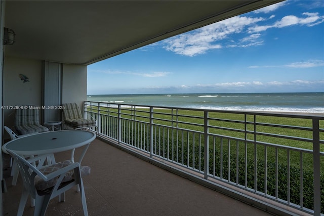 balcony with a water view and a beach view