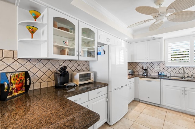 kitchen with white cabinetry, sink, light tile patterned floors, and white appliances