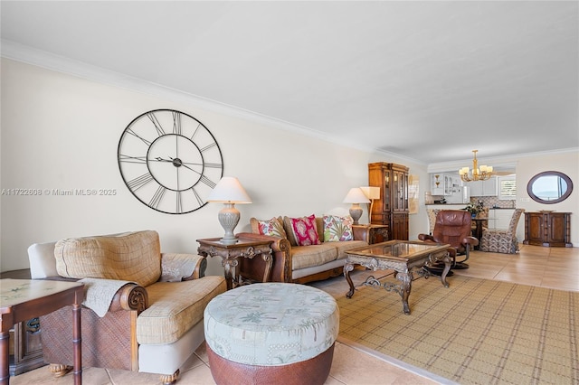 living room featuring light tile patterned floors, a chandelier, and ornamental molding